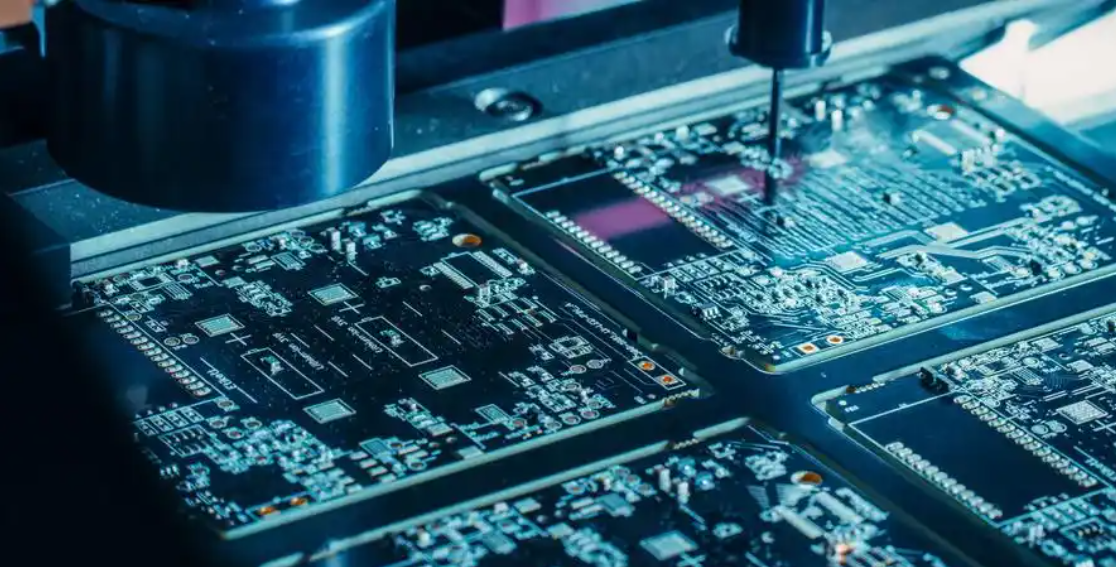 ICT fixture testing a PCB with bed-of-nails probes connected to a test system.